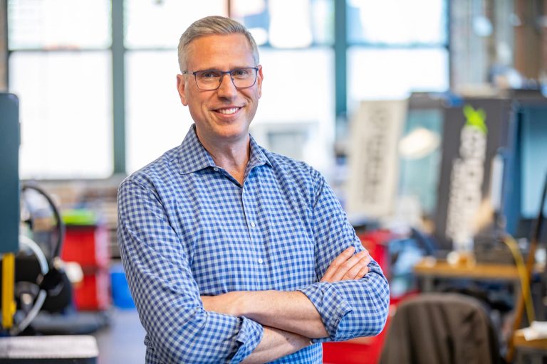 Illinois Treasurer Michael Frerichs is standing inside a workshop that is located inside a business incubator building on Chicago's West Side.