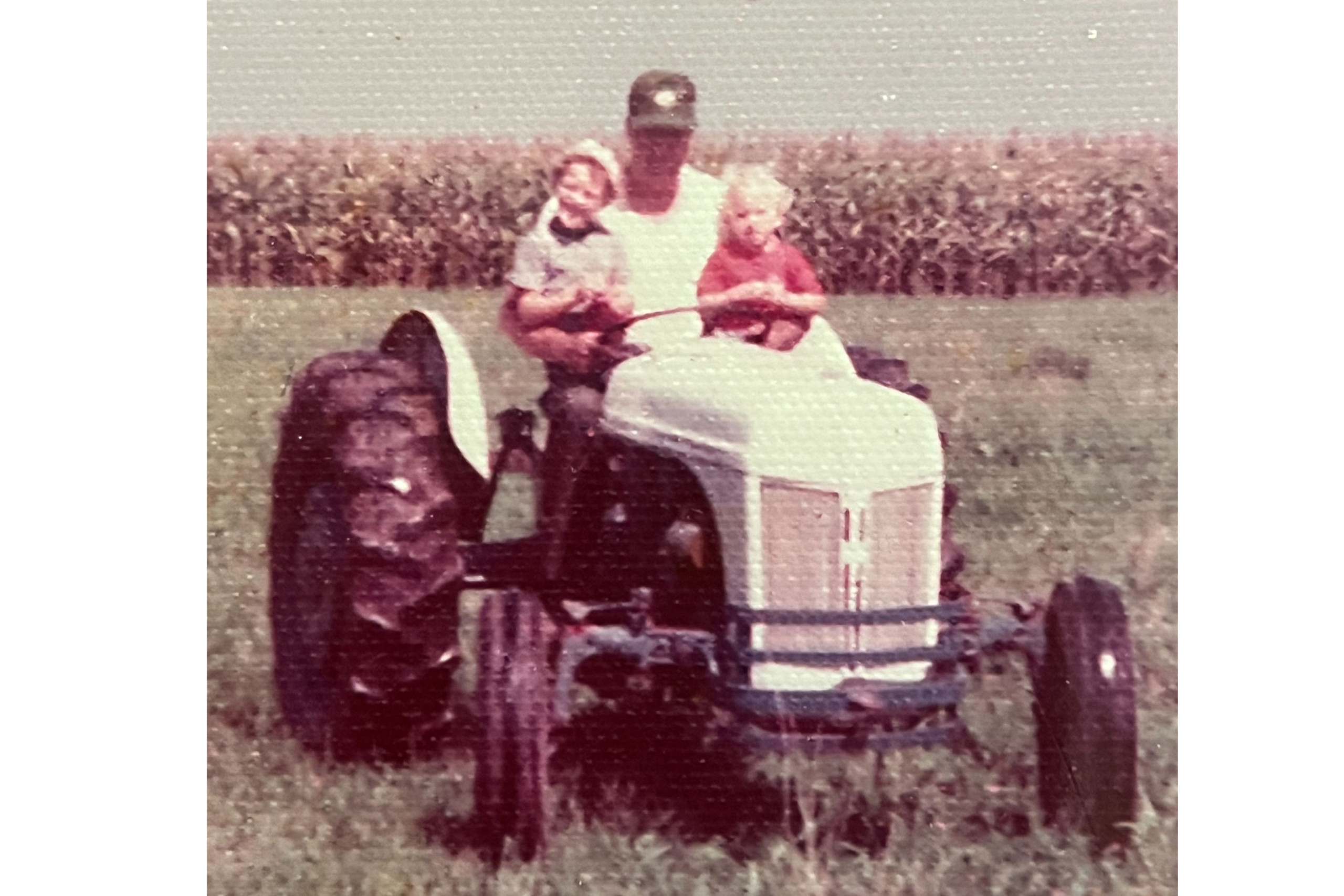 Childhood photo of Treasurer Frerichs with his grandfather on a tractor