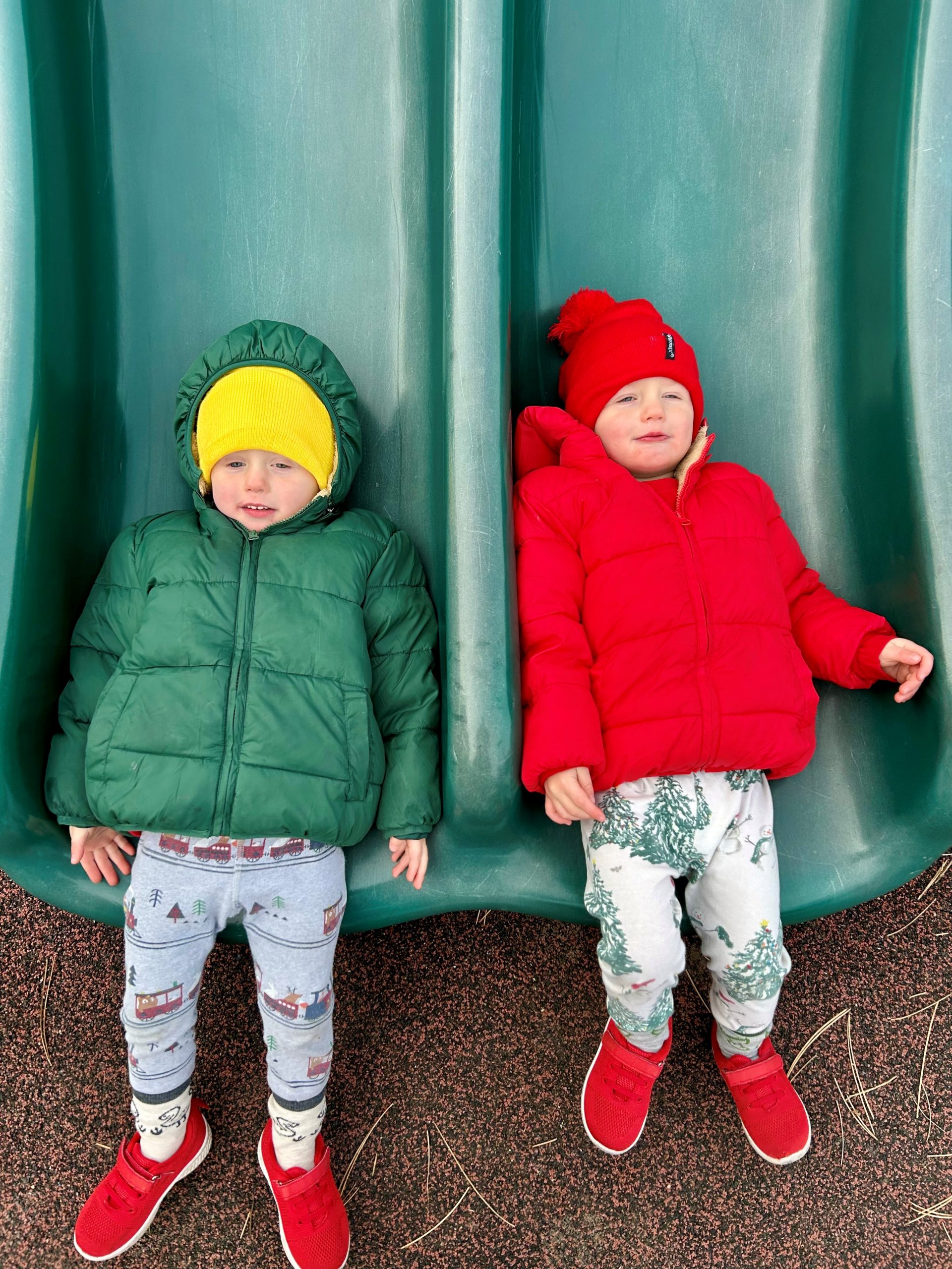 Twins on a slide during the Christmas season