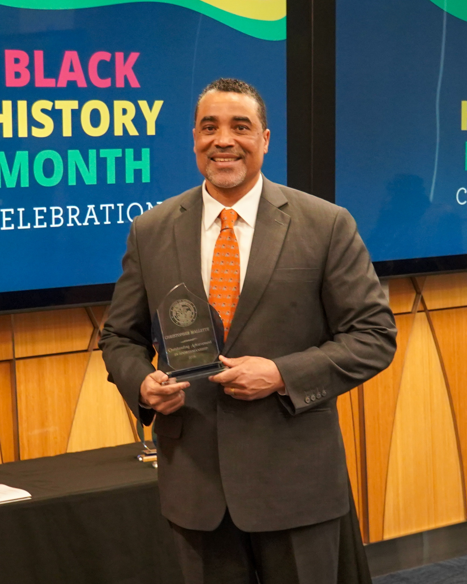 Christopher Mallette with award at Black History Month Event