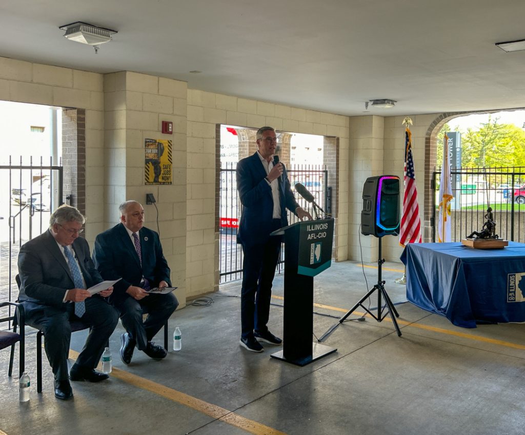 Treasurer Michael Frerichs addresses the crowd using a microphone