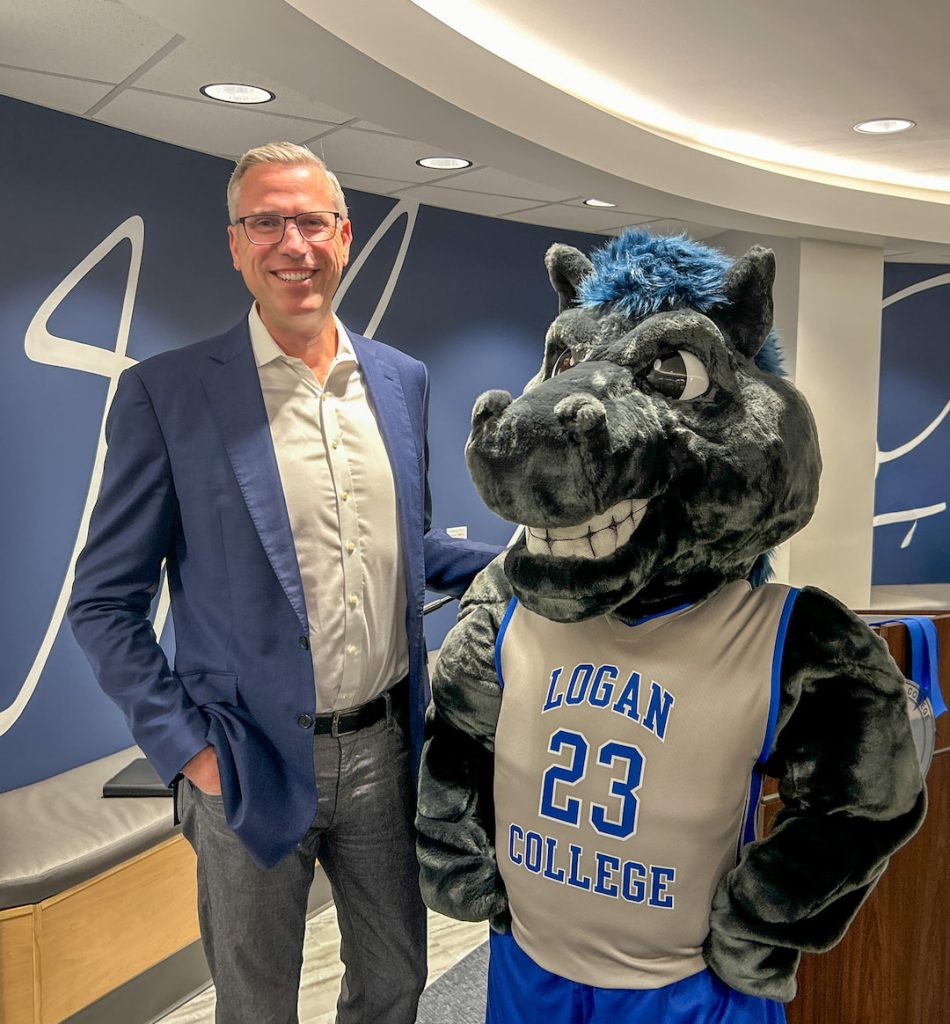 Treasurer Frerichs poses with Charger the horse mascot of John A. Logan College.