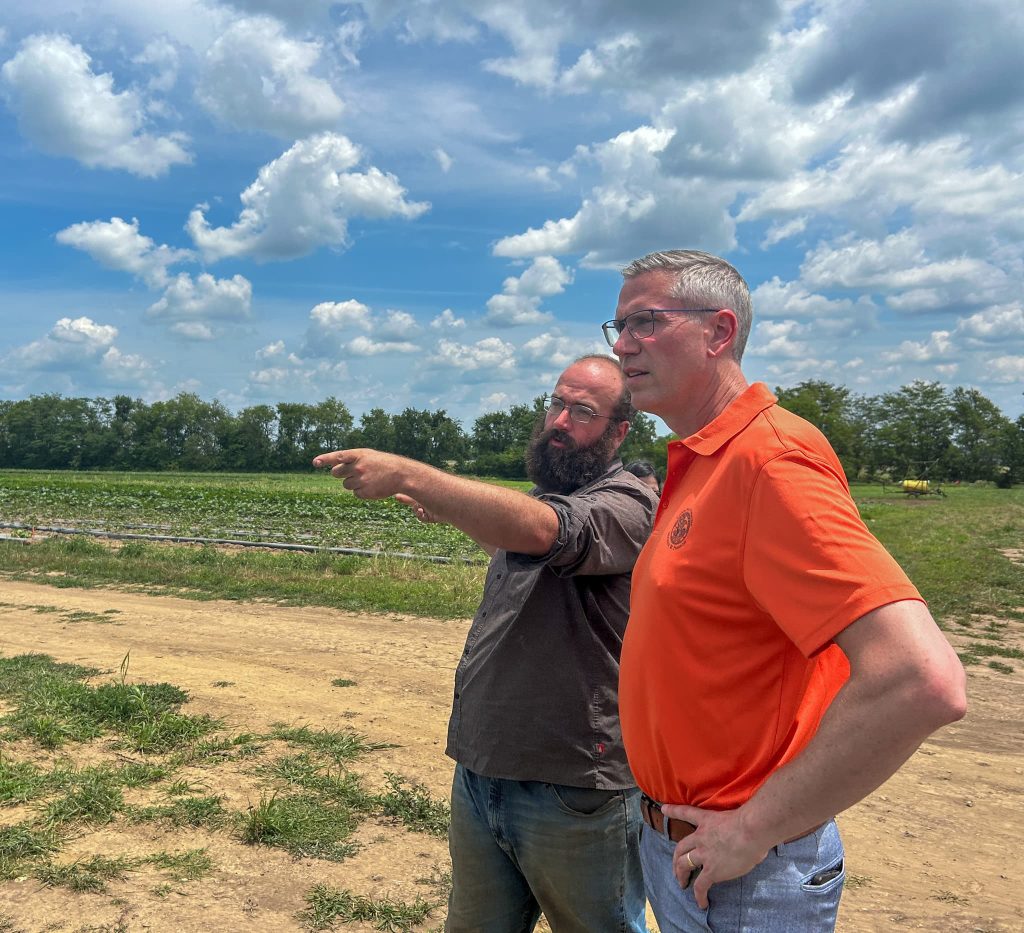 two men look at the fields in champaign county