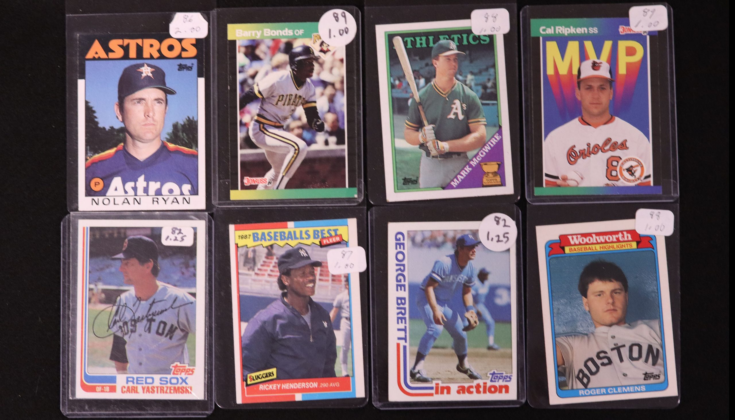 Eight baseball cards, including Nolan Ryan and Cal Ripken Jr.