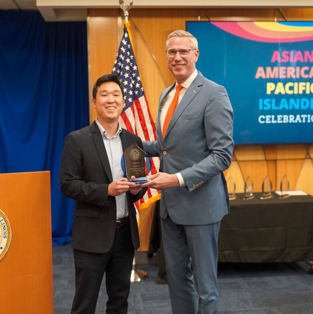 John Yi accepting award from Treasurer Frerichs. 