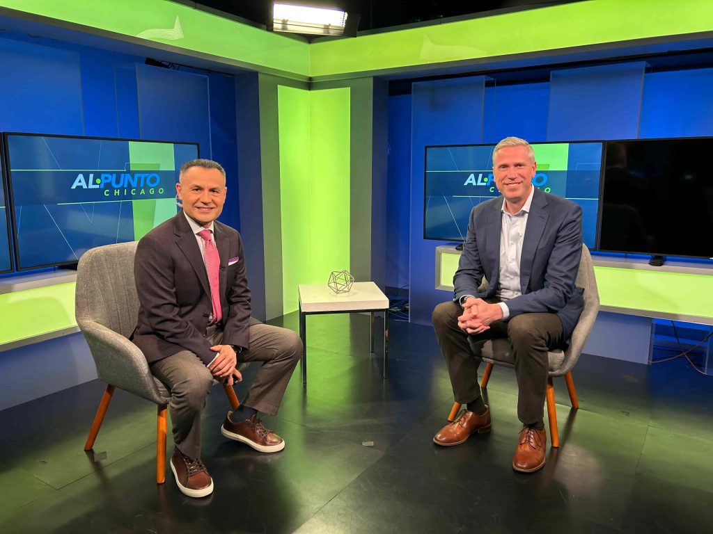 two men at a TV station sitting side by side in chairs