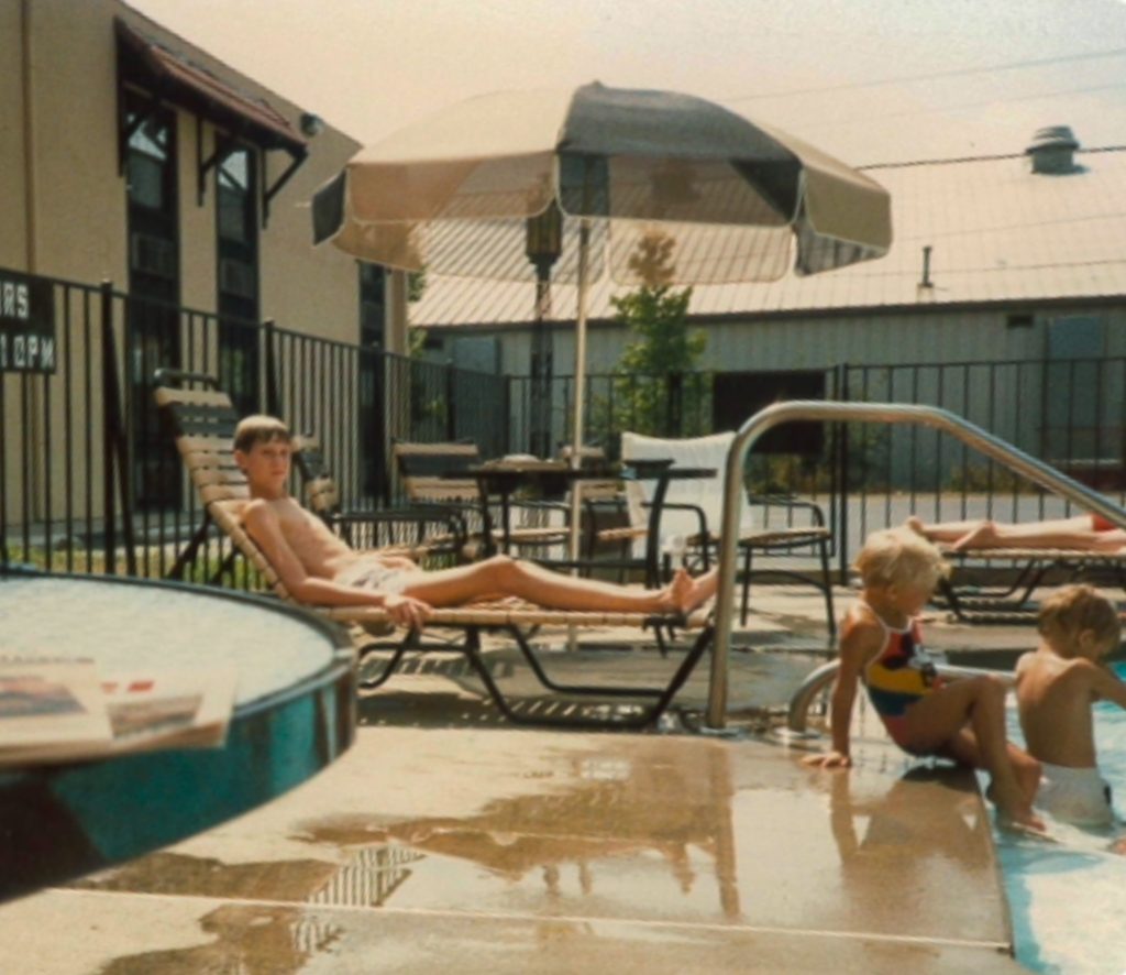 Treasurer Frerichs as a boy around age 12 or 13, relaxing in a chaise lounge beside a swimming pool. He is wearing swim trunks.