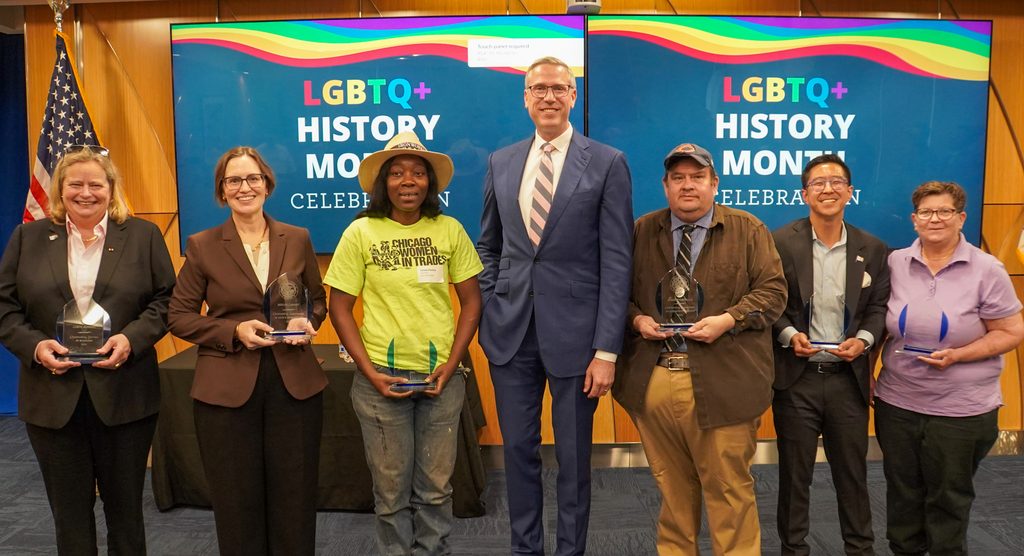 Treasurer Frerichs standing in the middle of a group of six award winners at the LGBTQ+ History Month celebration